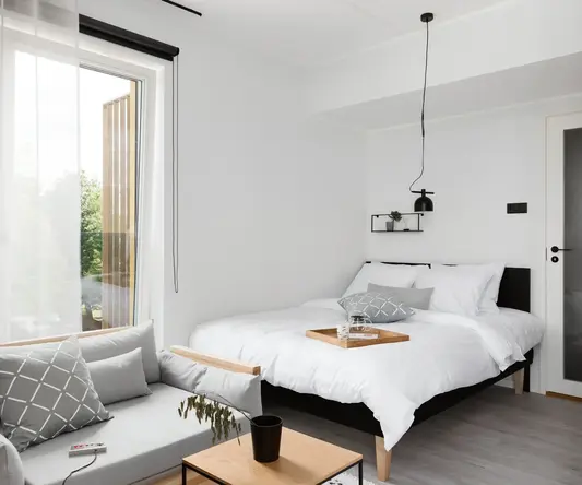 a bedroom with a bed and a couch