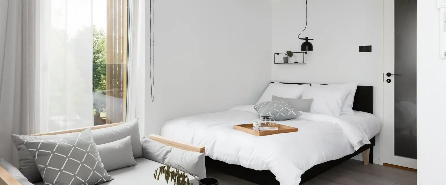 a bedroom with a bed and a couch