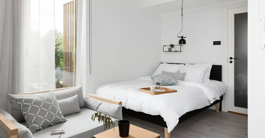 a bedroom with a bed and a couch