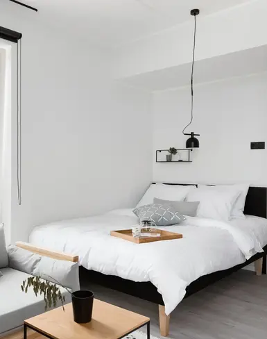 a bedroom with a bed and a couch