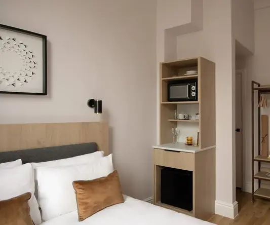 a room with a bed and a microwave