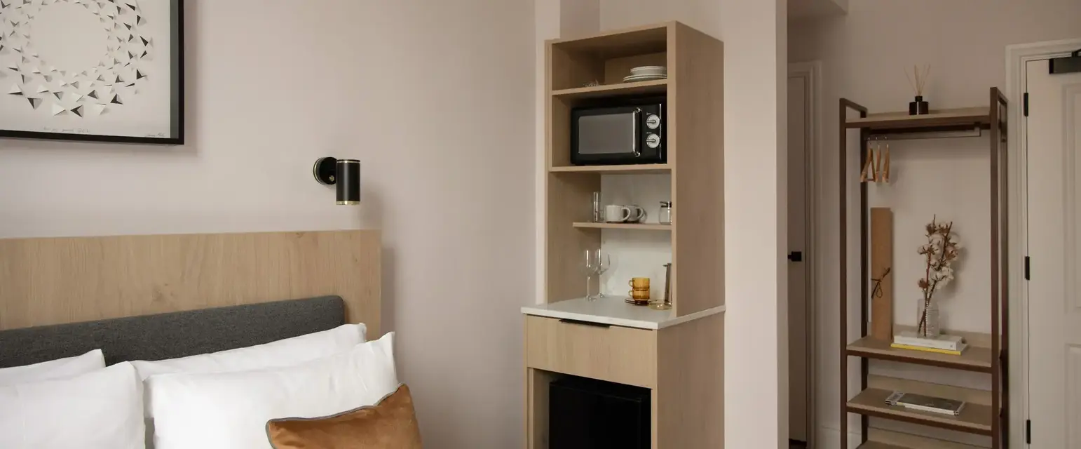 a room with a bed and a microwave