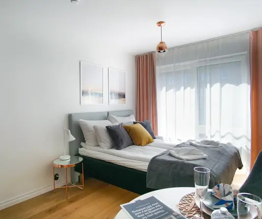 a bed with pillows and a table in a room