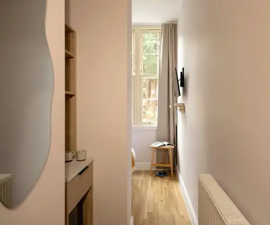 a hallway with a window and a table
