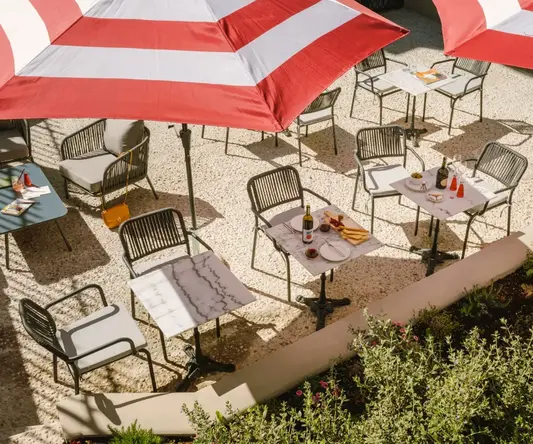 a table and chairs under umbrellas