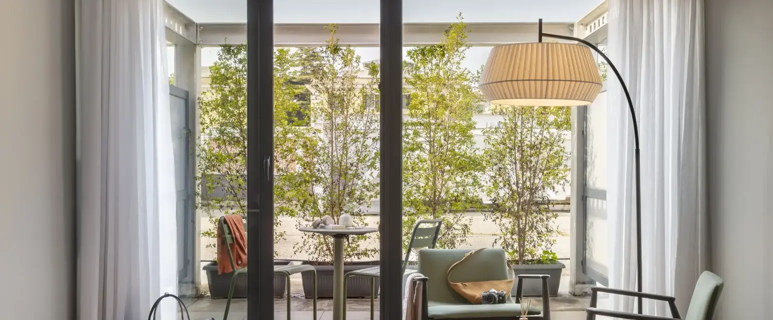a room with glass doors and a table and chairs