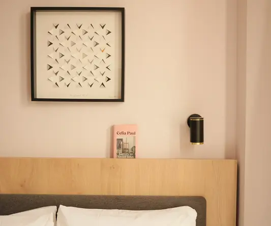 a bed with a picture on the wall