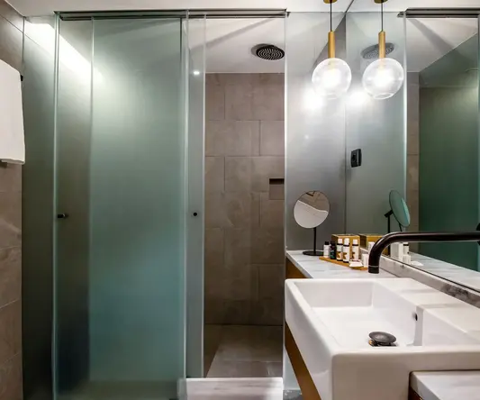 a bathroom with a glass shower door