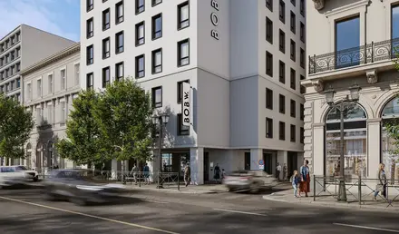 a group of buildings with trees and cars