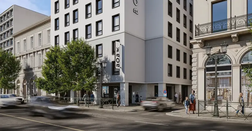 a group of buildings with trees and cars