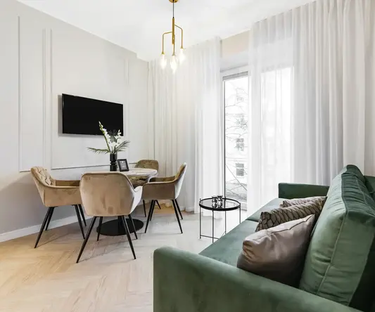 a living room with a green couch and a table