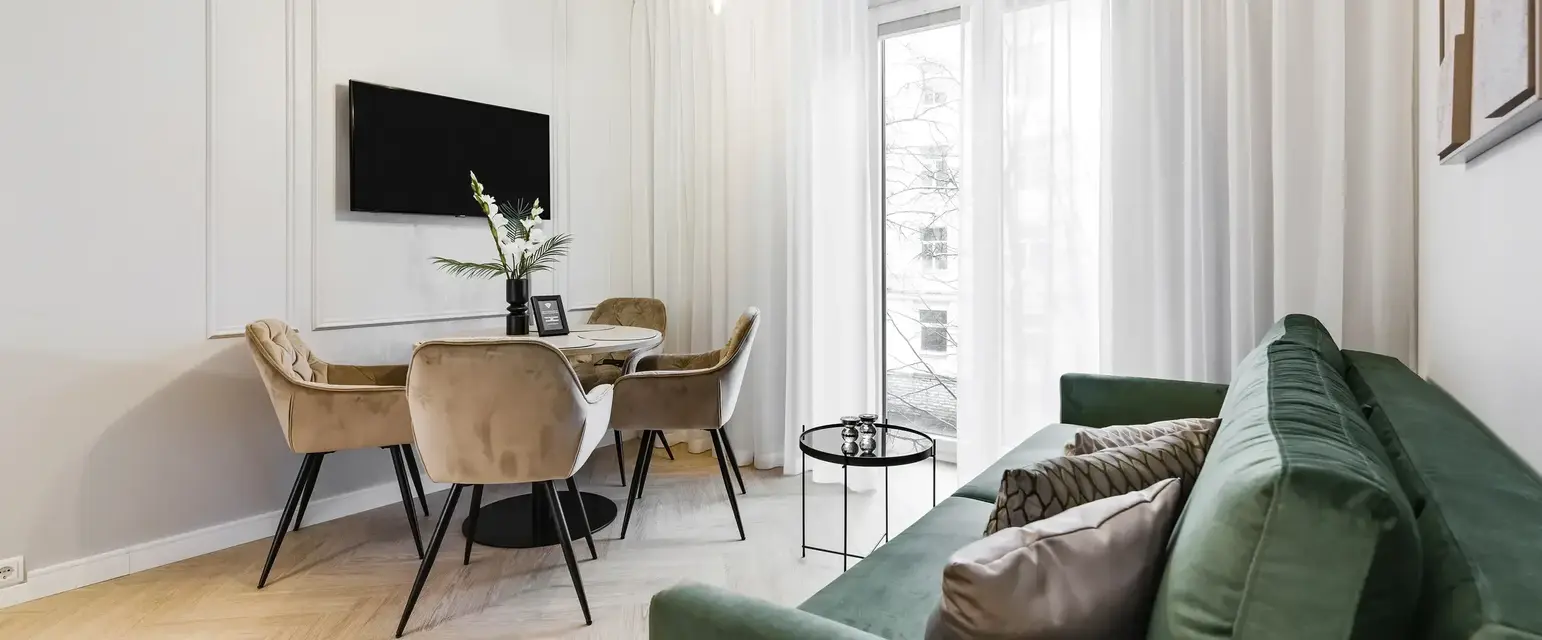 a living room with a green couch and a table