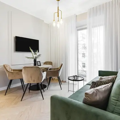 a living room with a green couch and a table