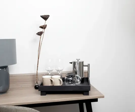 a tray with cups and glasses on a table