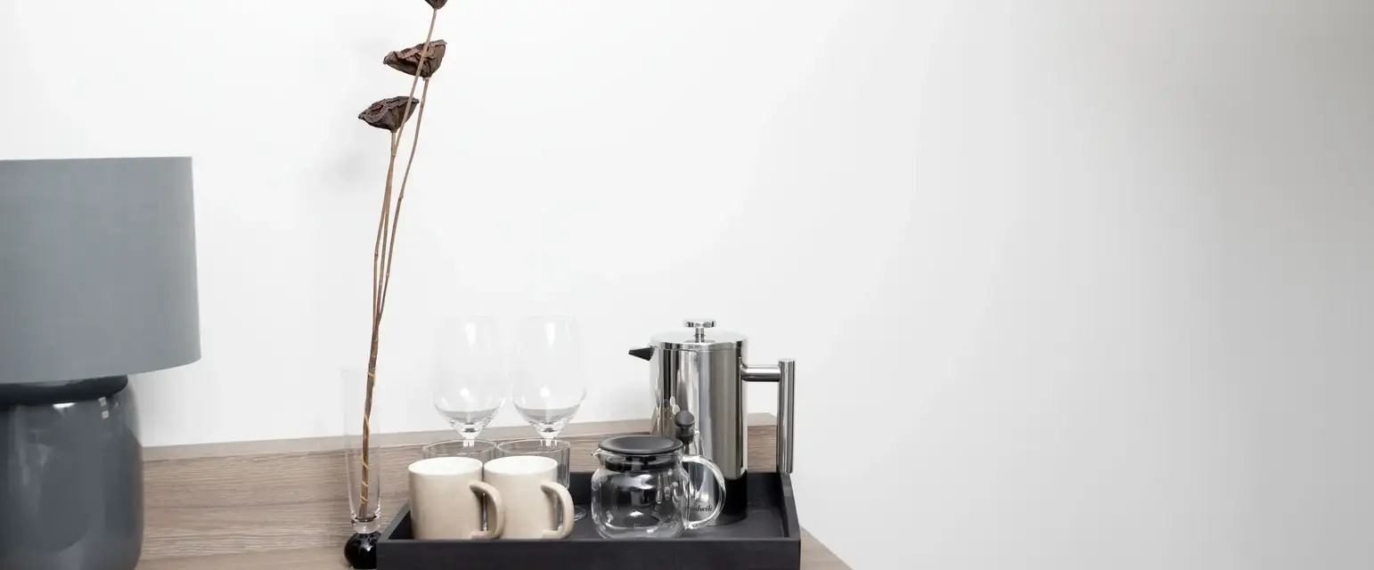 a tray with cups and glasses on a table