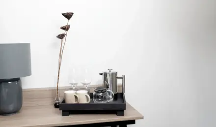 a tray with cups and glasses on a table