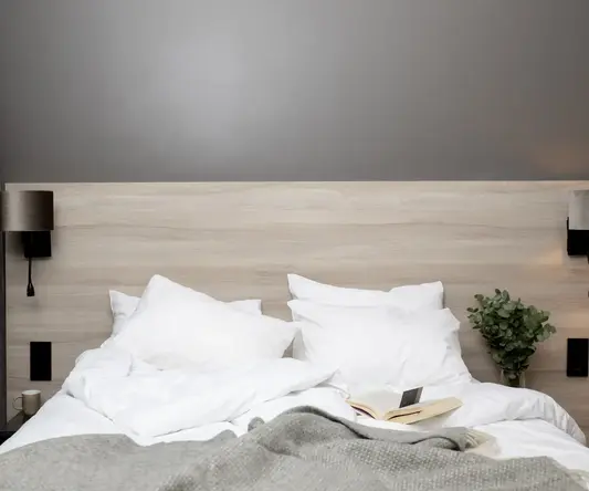 a bed with pillows and a book on it