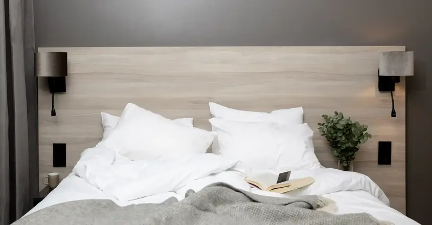 a bed with pillows and a book on it