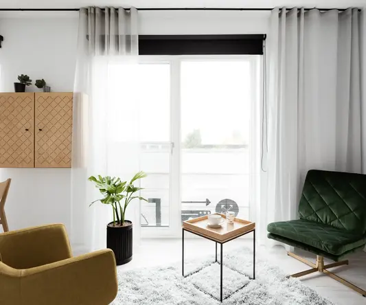 a room with a green chair and a coffee table