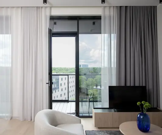 a living room with a television and a glass door