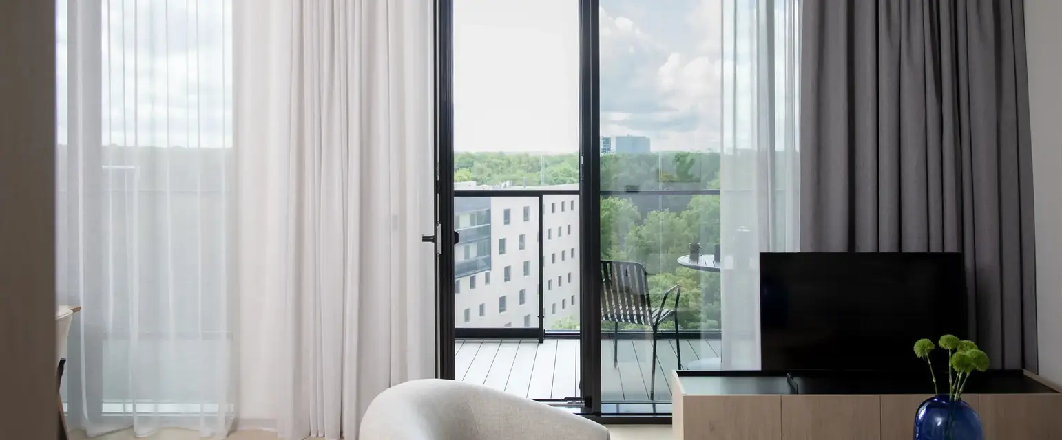 a living room with a television and a glass door