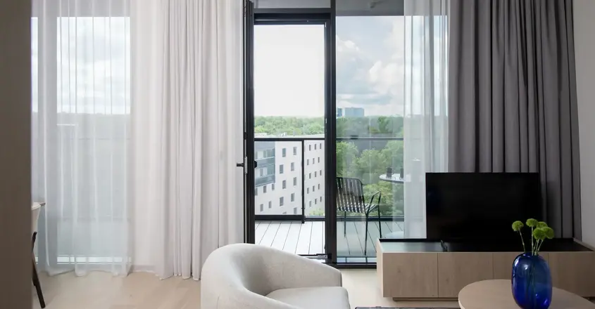 a living room with a television and a glass door