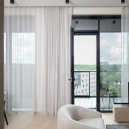 a living room with a television and a glass door
