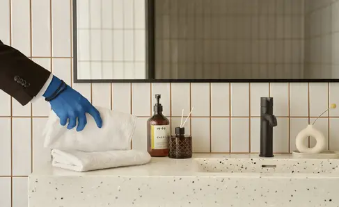a person cleaning a bathroom sink