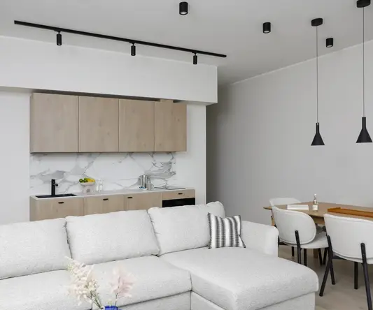 a living room with a couch and kitchen