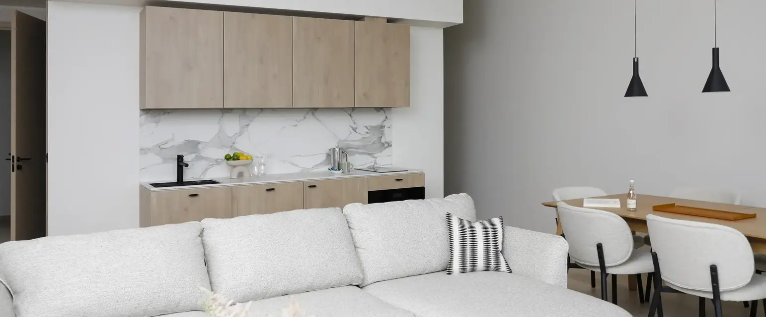 a living room with a couch and kitchen