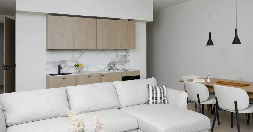 a living room with a couch and kitchen