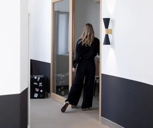 a woman walking through a doorway