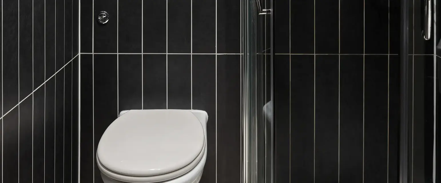 a bathroom with a glass shower door
