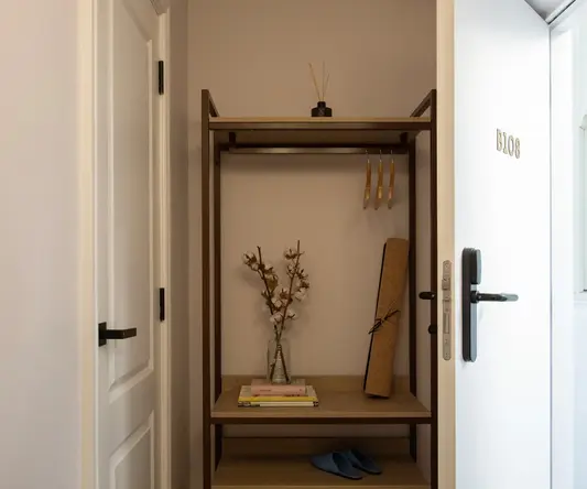 a shelf with books and a plant on it