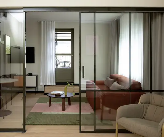 a glass door with a couch and a table in front of it