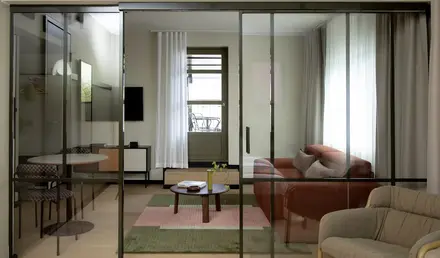 a glass door with a couch and a table in front of it