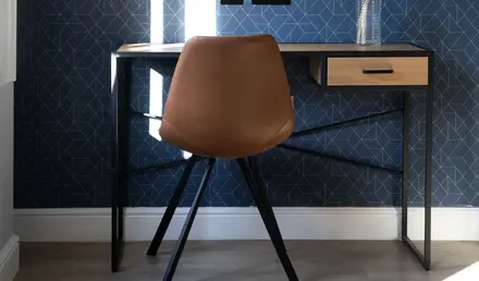 a chair next to a desk