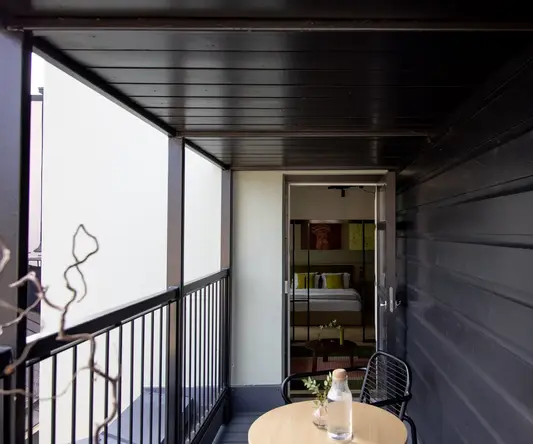 a small balcony with a table and chair