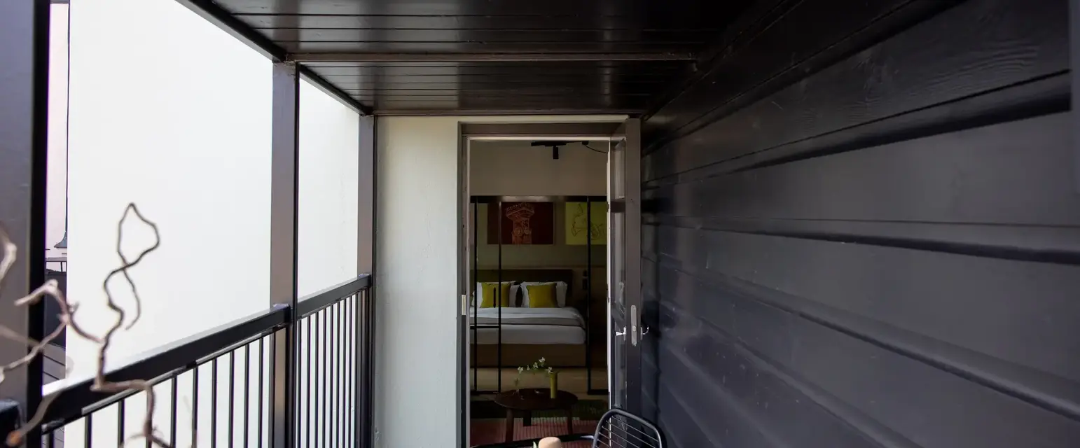 a small balcony with a table and chair