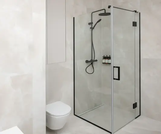 a bathroom with a glass shower and toilet
