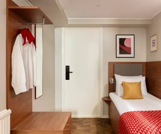 a bedroom with a bed and a white door