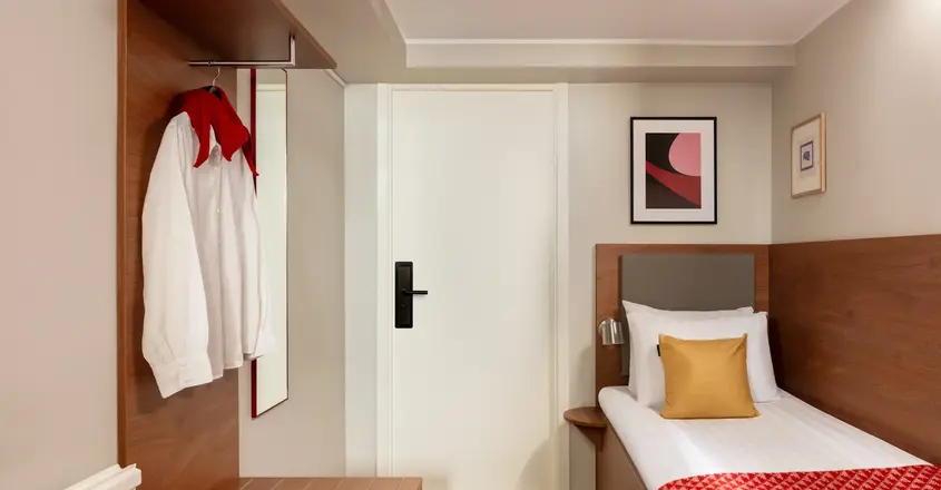 a bedroom with a bed and a white door