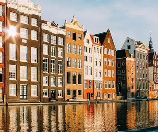a row of buildings next to a body of water