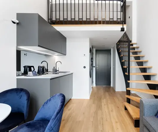 a room with a staircase and a couch