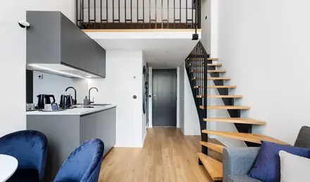 a room with a staircase and a couch