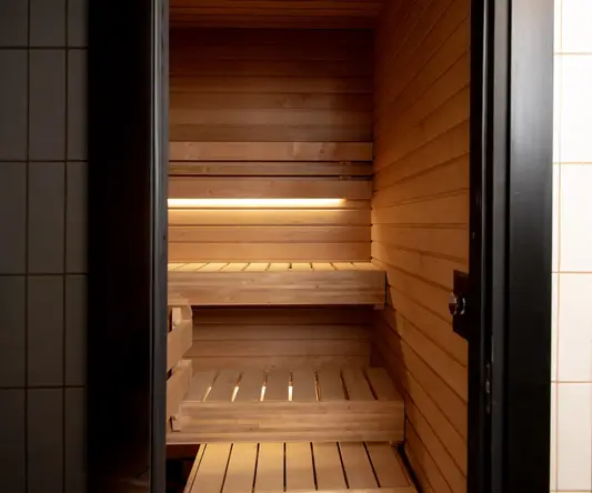a wooden sauna with a door open