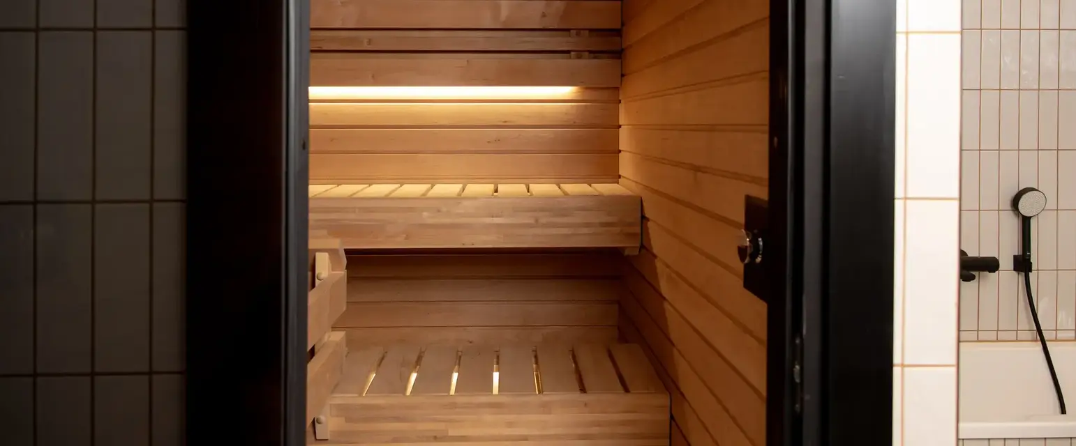 a wooden sauna with a door open
