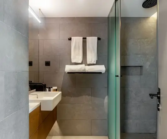 a bathroom with a shower and a sink