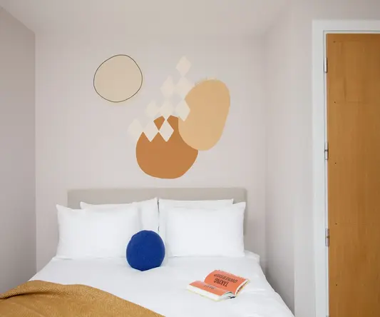 a bed with pillows and a book on it