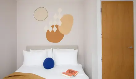 a bed with pillows and a book on it